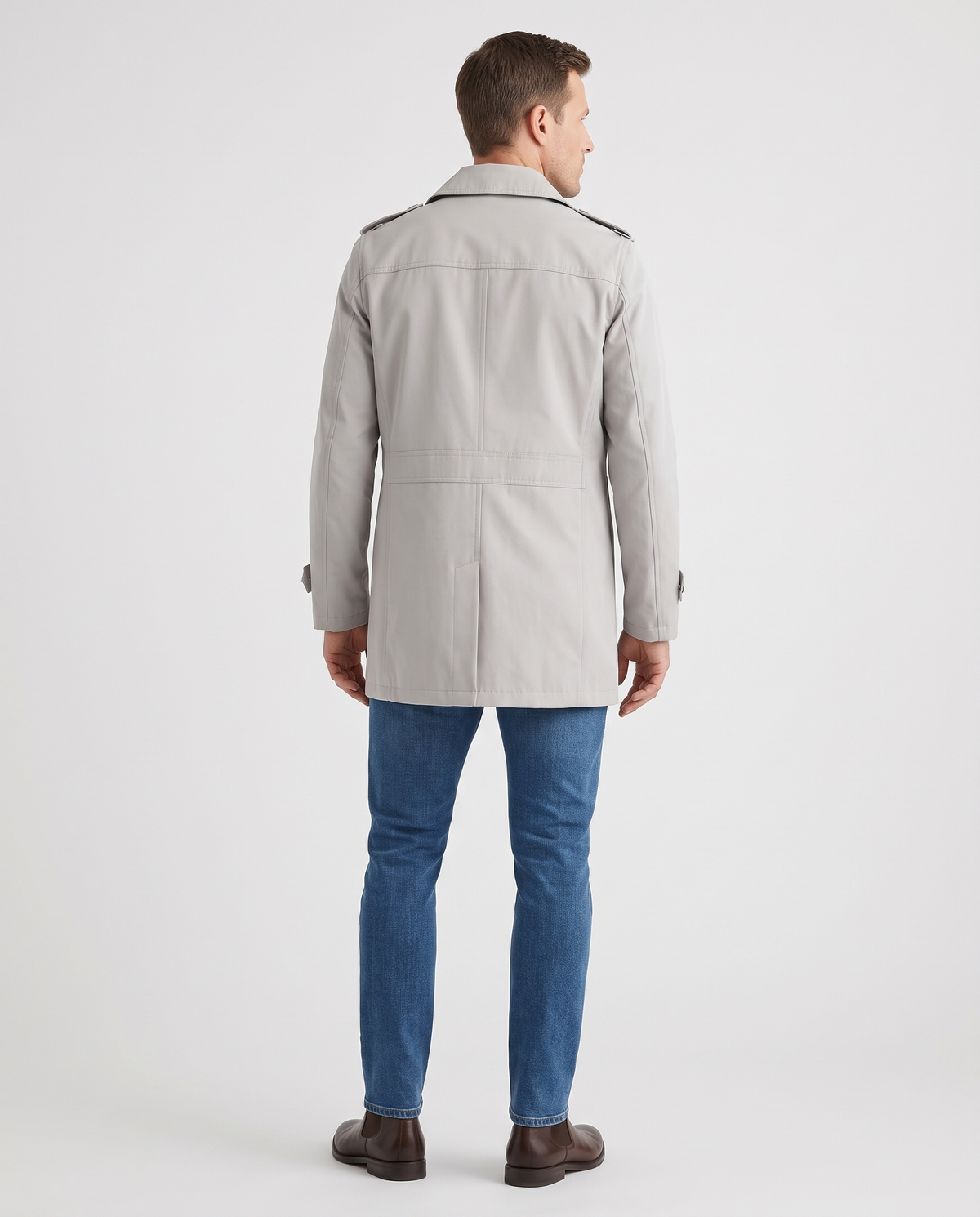 A man wearing a light gray single-breasted trench coat with a mid-length fit and tailored silhouette, back view
