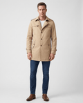 A man wearing a beige single-breasted trench coat with a mid-length fit, structured lapels, and tailored silhouette