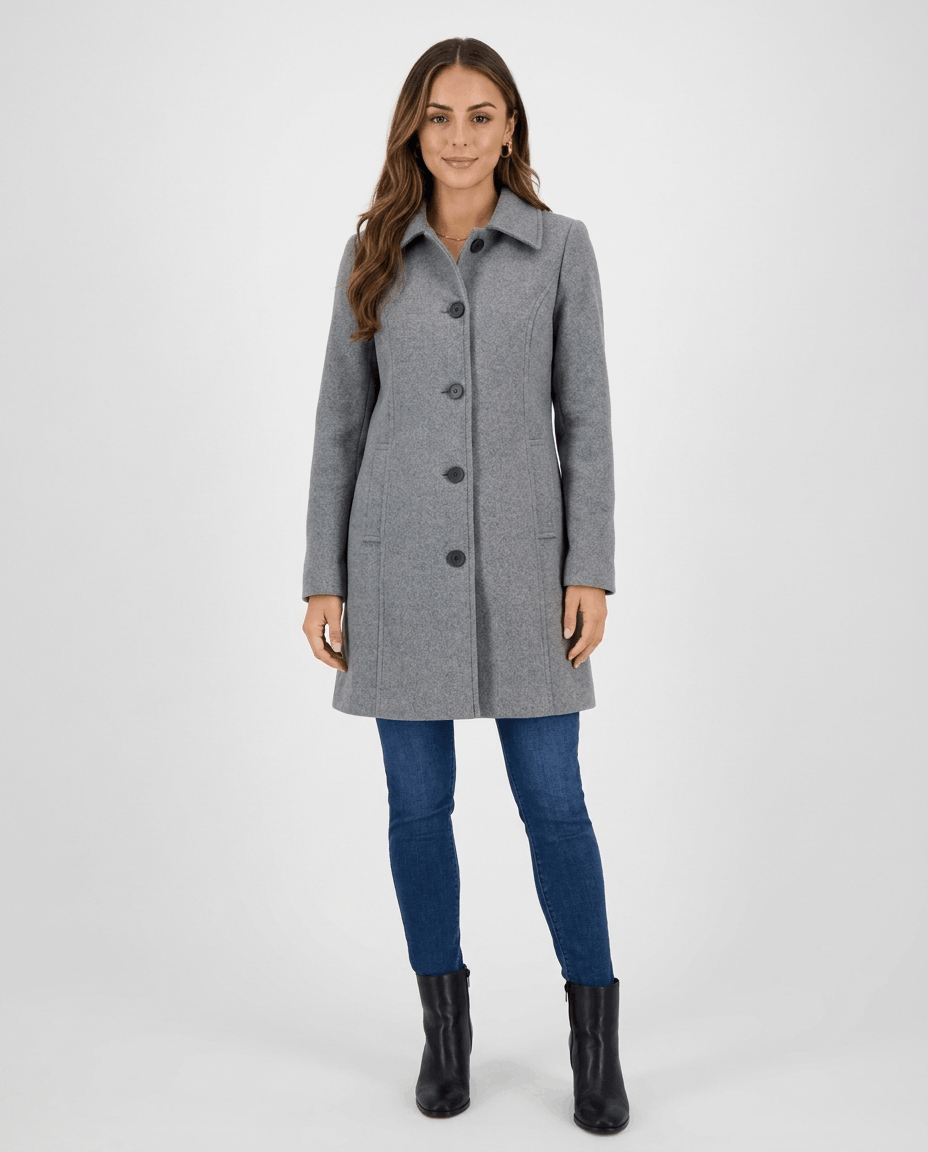 A woman wearing a gray single-breasted mid-length trench coat with a button front and tailored fit