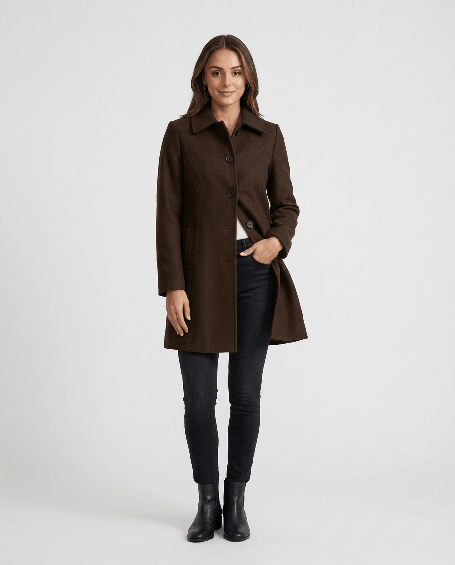 A woman wearing a dark brown single-breasted mid-length trench coat with a tailored fit and button front