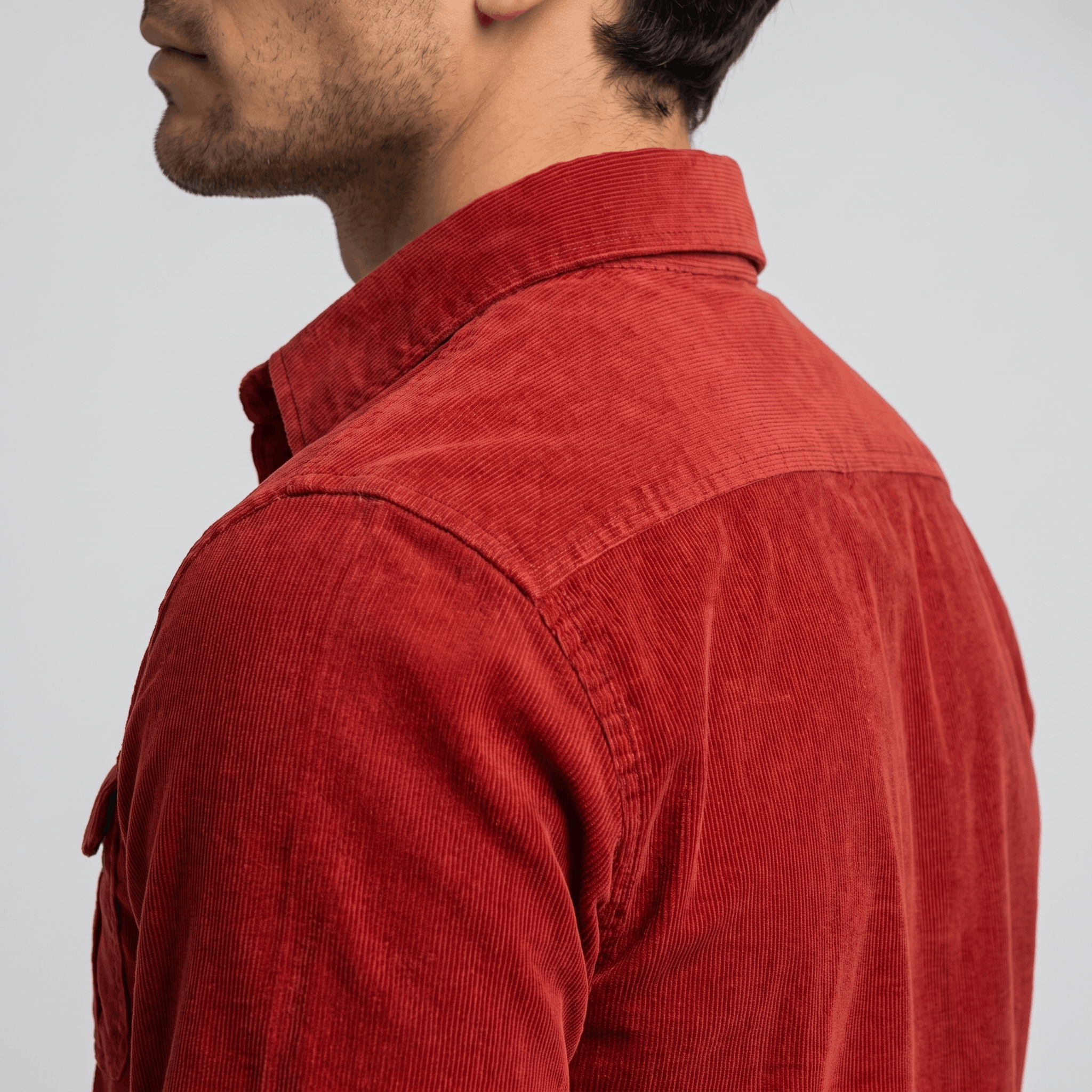 Red fine-wale corduroy shirt featuring a spread collar and regular fit, shown from the side profile.
