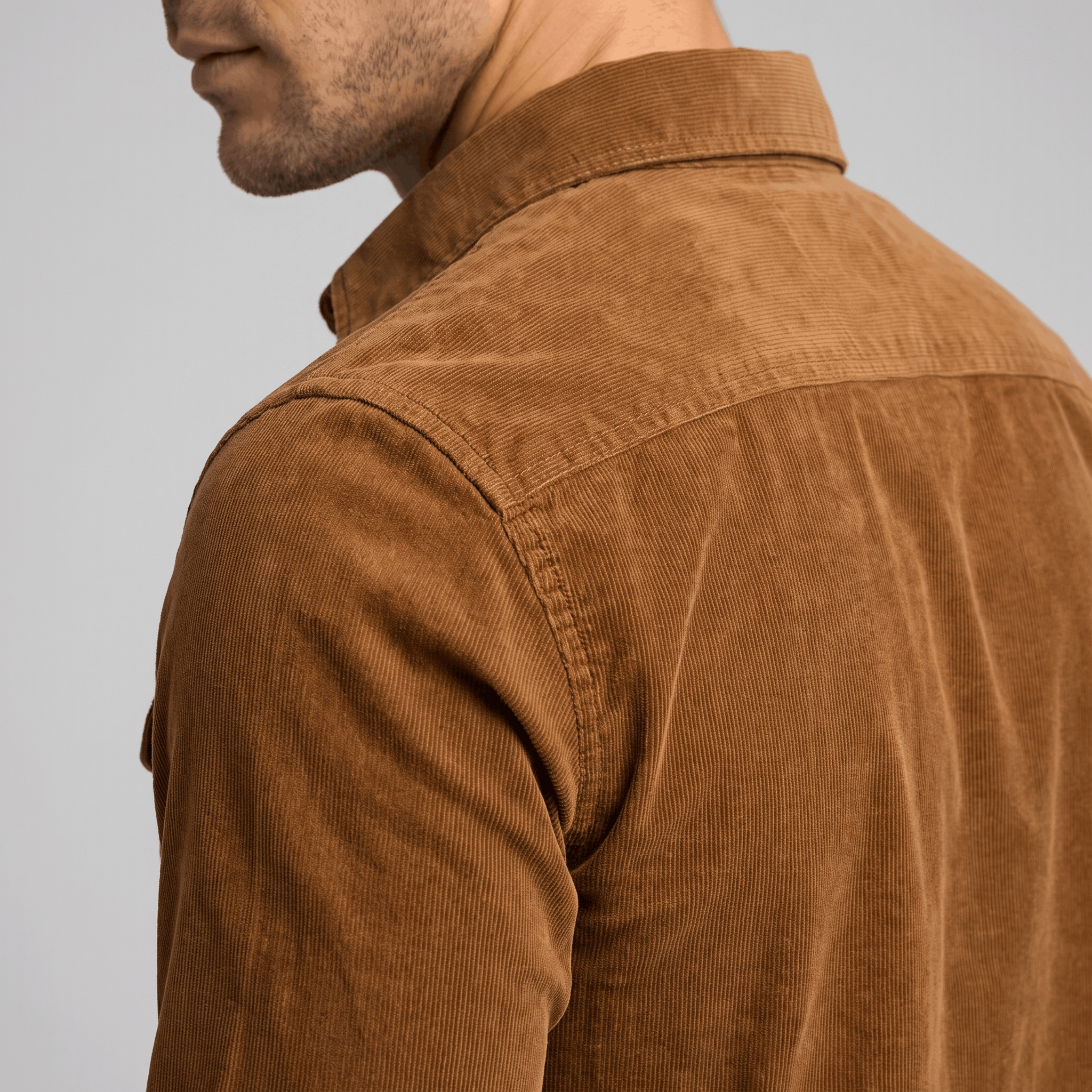 Brown corduroy shirt with fine ribbing, spread collar, and regular fit, shown from the back and side.