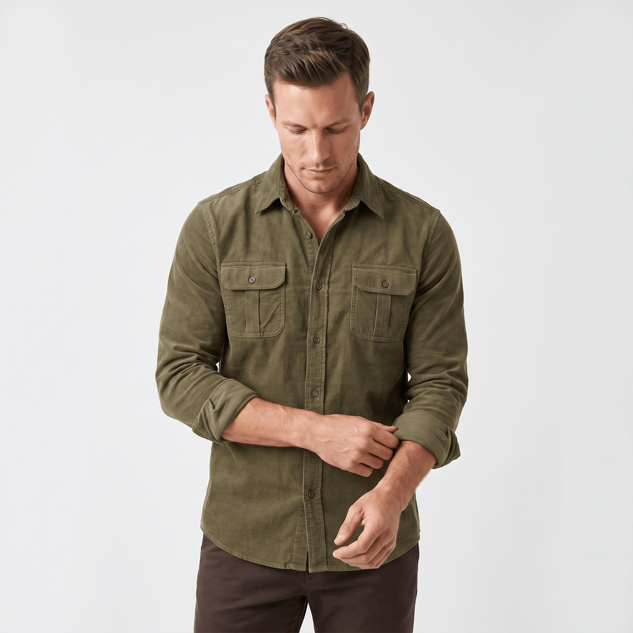 Olive green fine-wale corduroy shirt with a spread collar and twin button-flap chest pockets in a regular fit.
