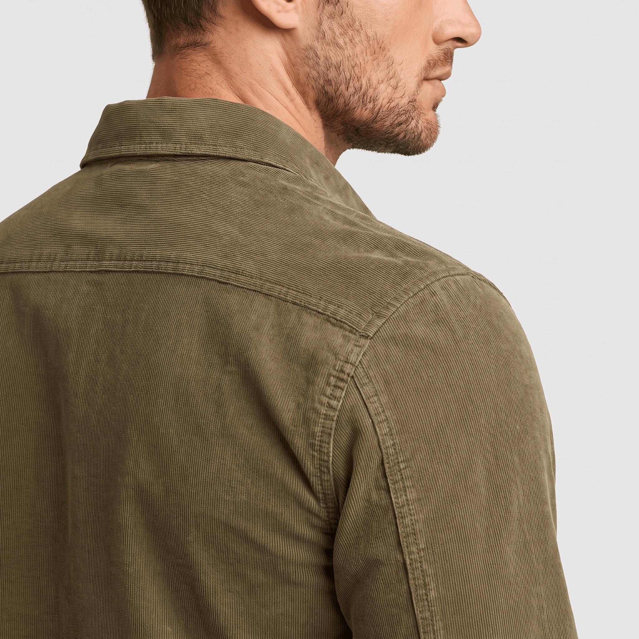 Olive green corduroy shirt with fine ribbing, spread collar, and structured back yoke in a regular fit.