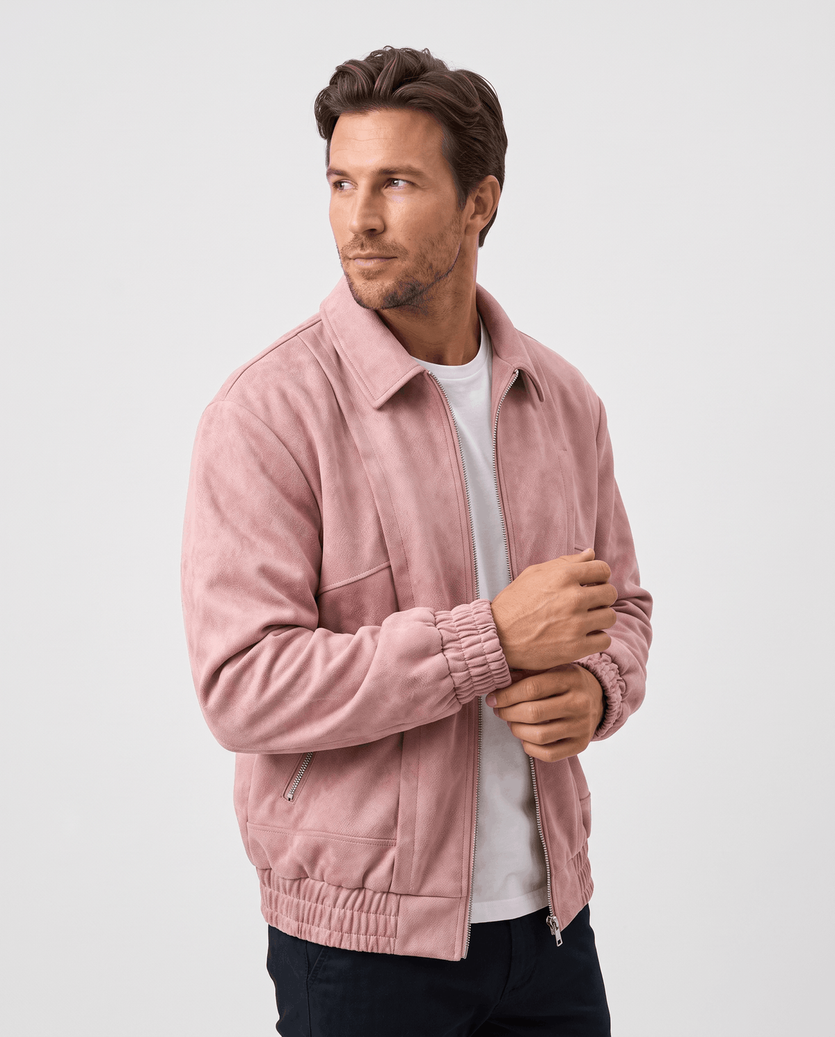 A man wearing a pink suede bomber jacket with a relaxed fit and zip pockets