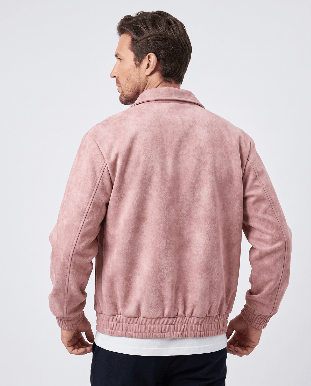 A man wearing a pink suede bomber jacket with a relaxed fit, shown from the back