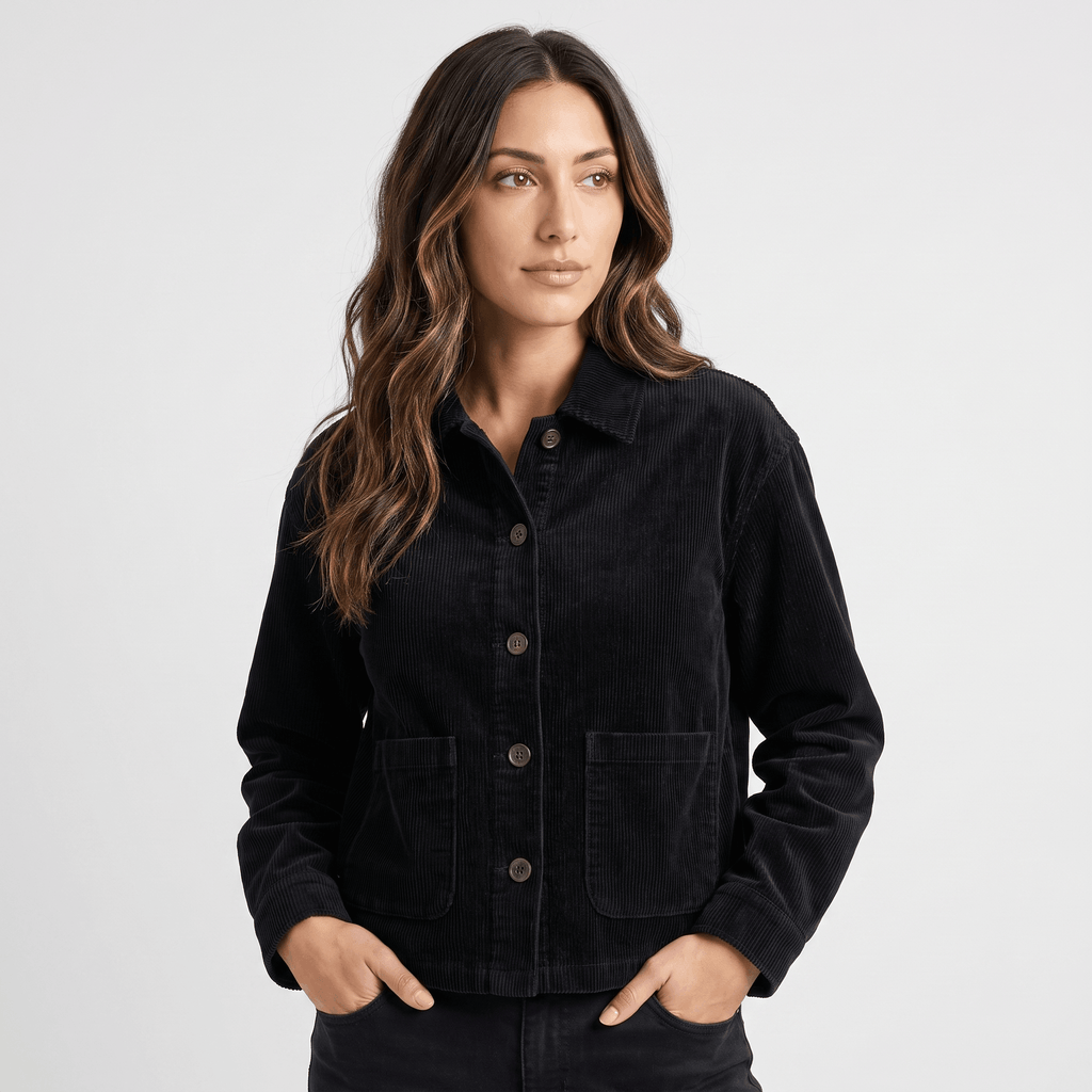 Black cotton corduroy chore jacket with a boxy fit, button-front closure, and deep patch pockets.