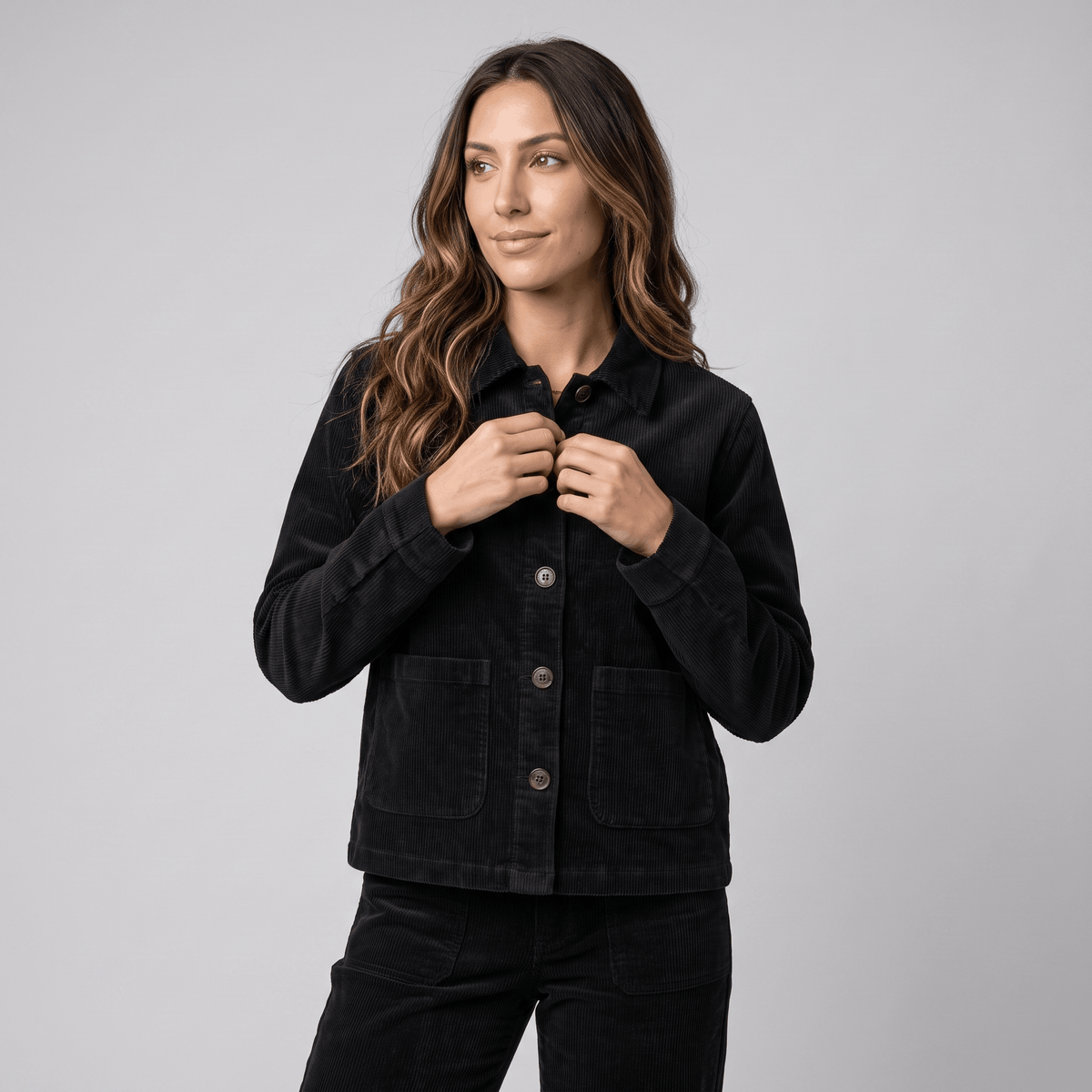 Black cotton corduroy chore jacket with a boxy fit, button-front closure, and deep patch pockets.