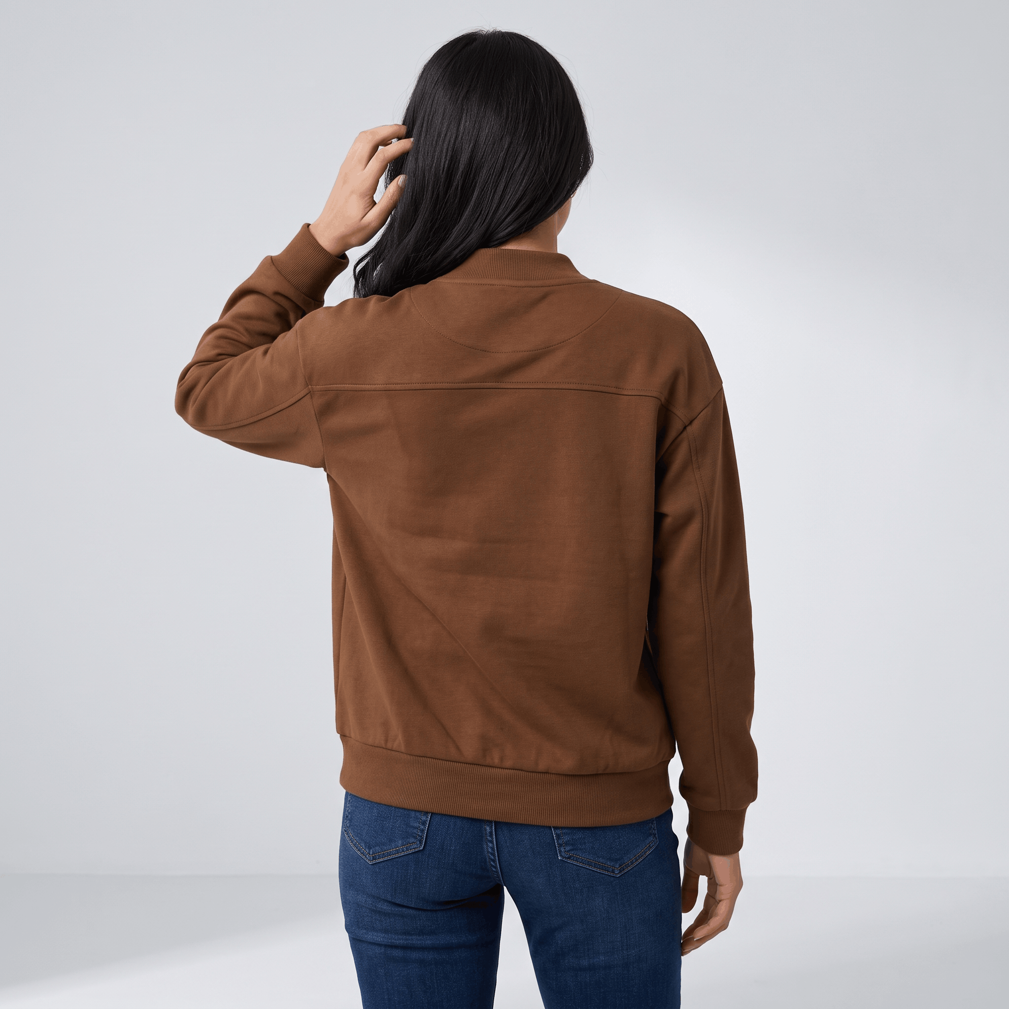 Female model wearing the brown jacket, showing the back and relaxed fit.