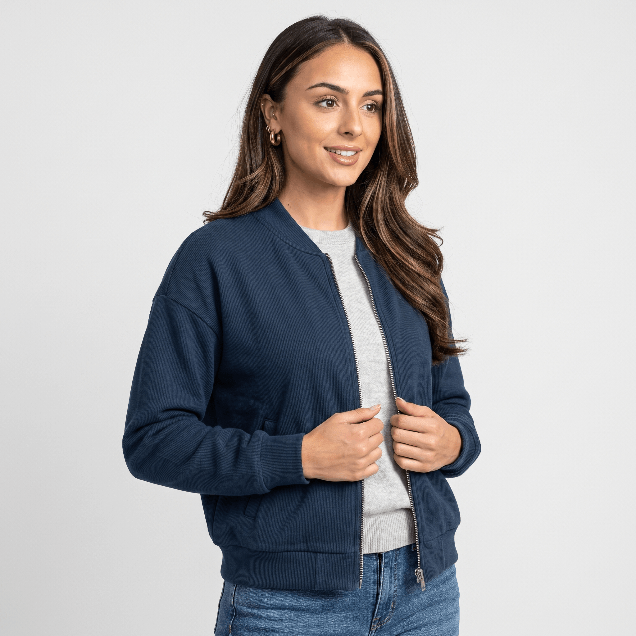 Female model wearing a navy blue zip-up jacket with a stand collar, side pockets, and ribbed cuffs and hem.