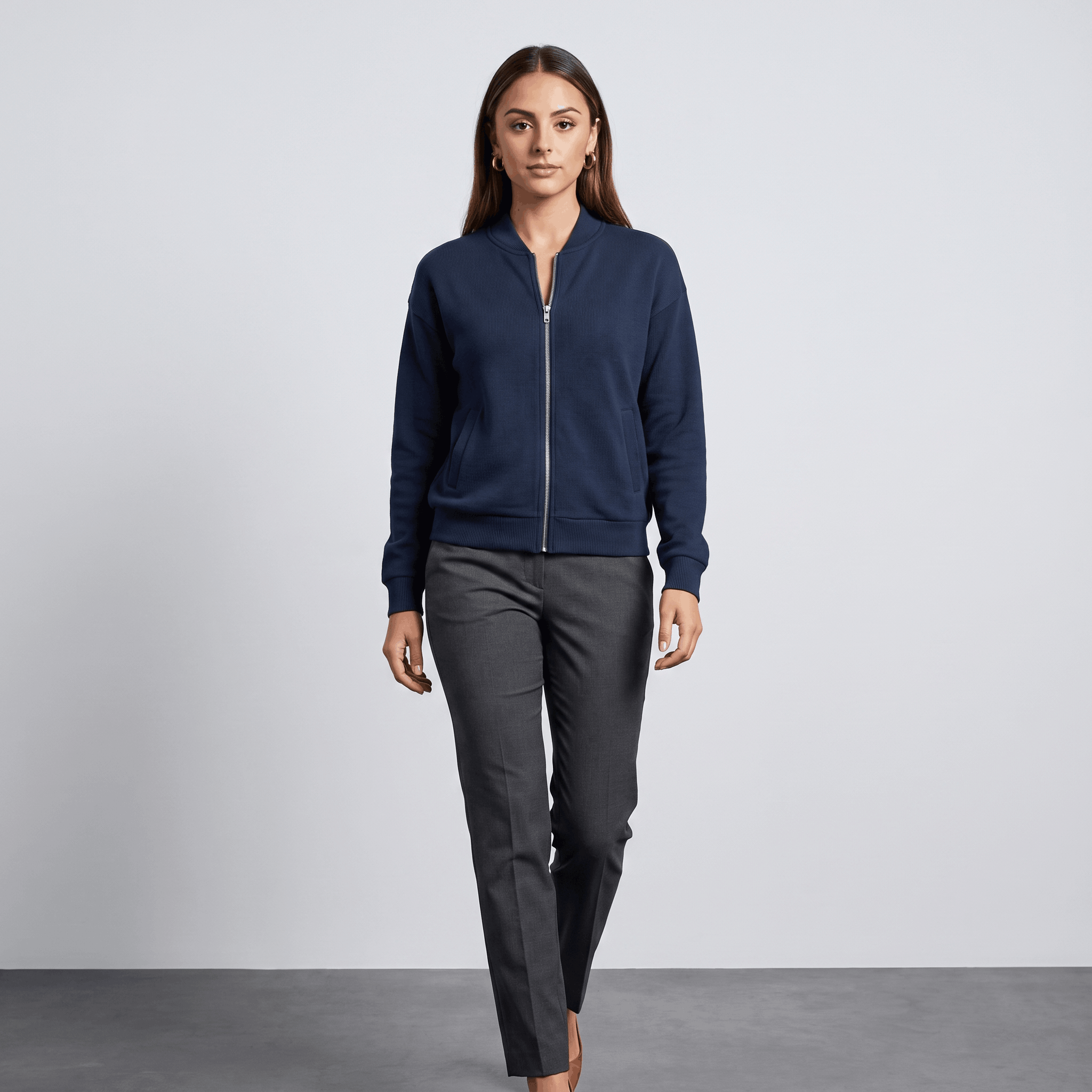 Female model wearing the navy blue jacket with dark trousers and black shoes.