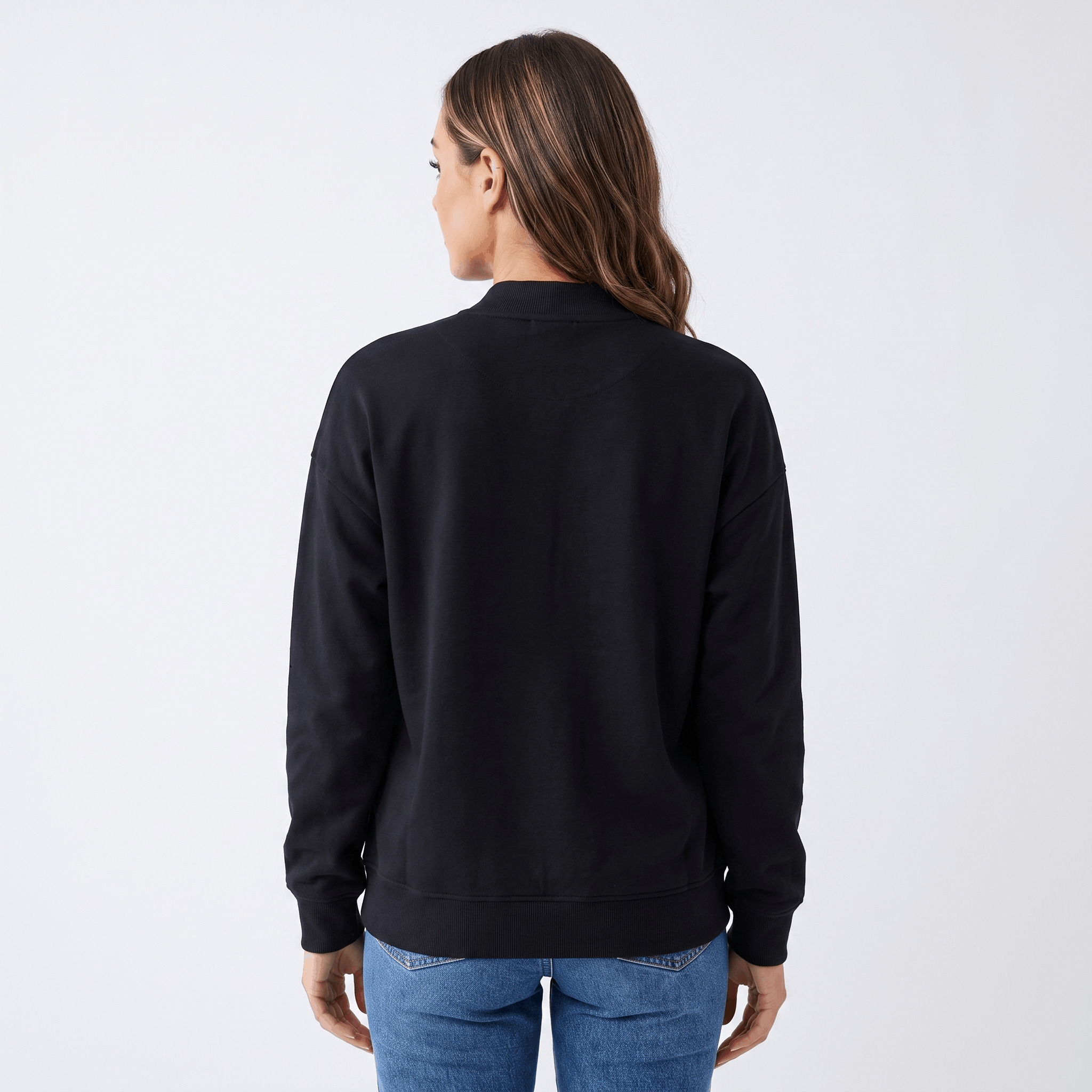 Female model wearing the black jacket, showing the back and relaxed fit.