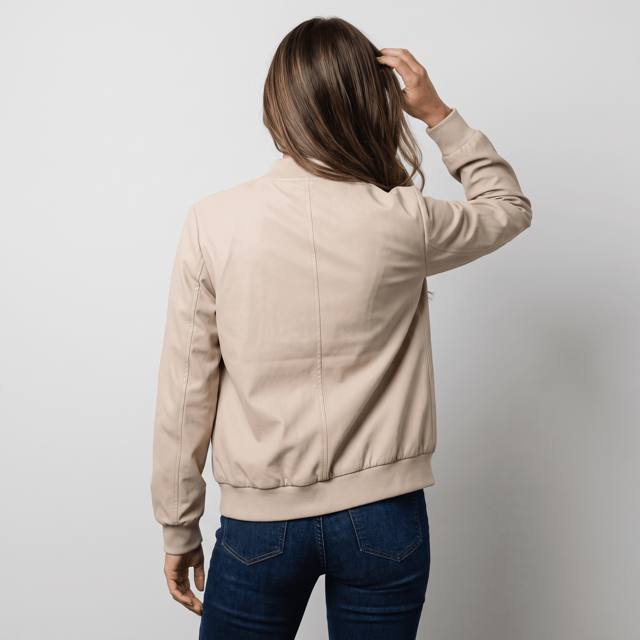 Female model wearing the cream beige jacket, showing the back and fitted shape.