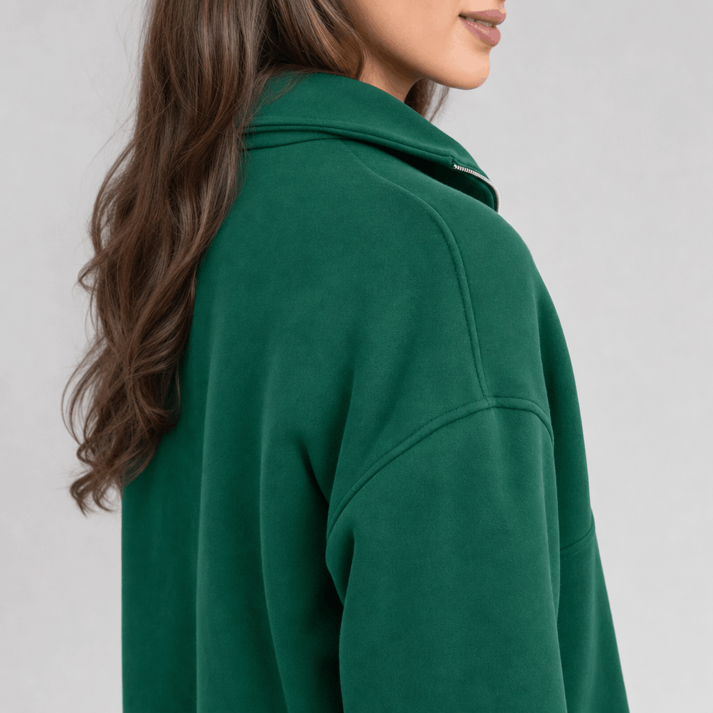 Back and side close-up of the dark green quarter-zip pullover, showing the raised collar and relaxed fit.