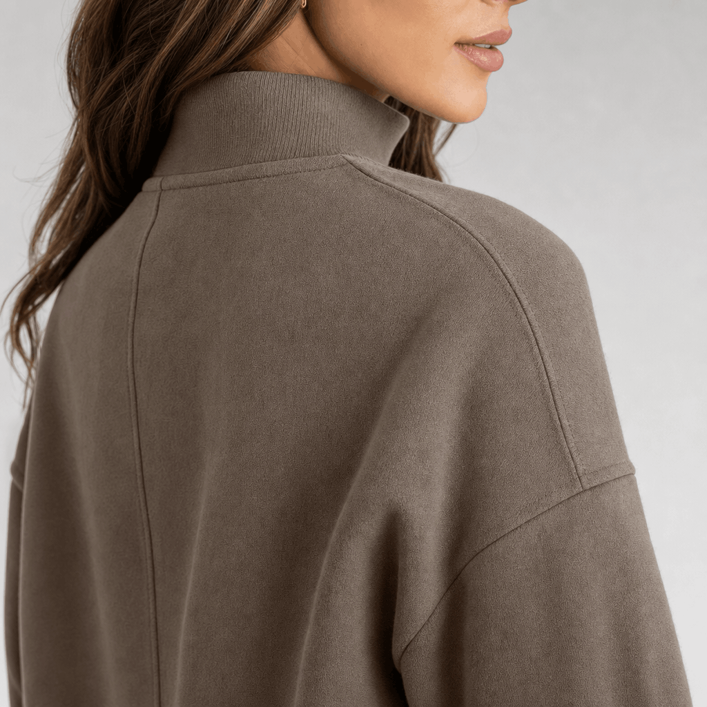Back and side close-up of the taupe quarter-zip pullover, highlighting the raised collar and relaxed shoulder fit.