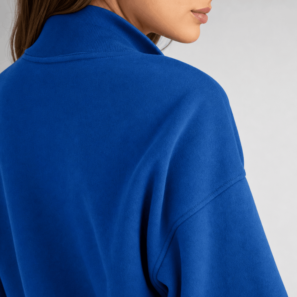 Back close-up of the bright blue quarter-zip pullover, showing the raised collar and relaxed fit.
