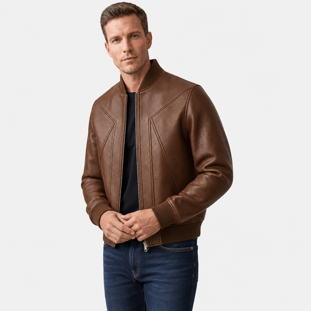 Male model wearing a brown leather-style zip-up jacket with blue jeans.