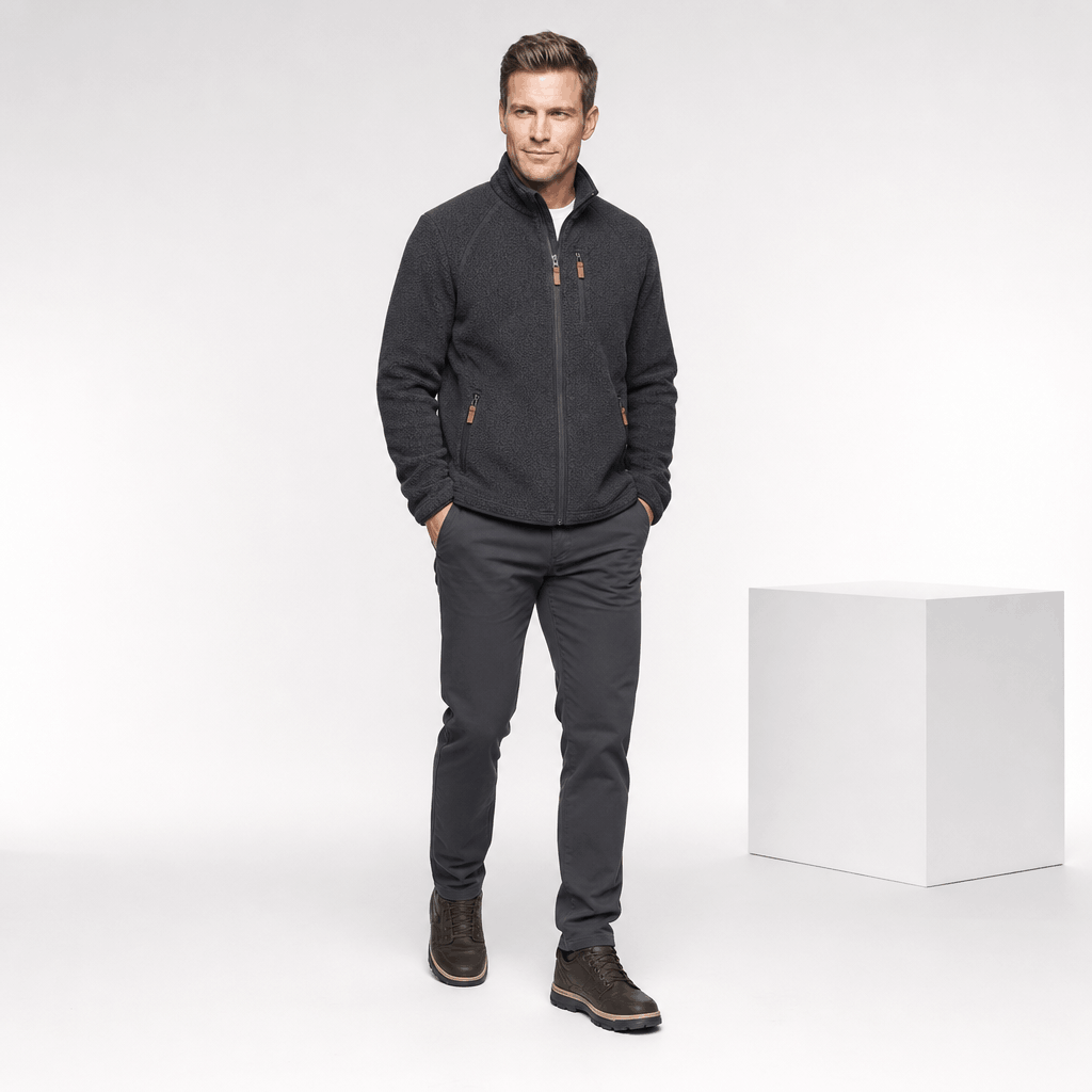 Male model wearing the dark charcoal fleece jacket with dark pants.