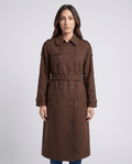 Brown belted double-breasted trench coat with notched collar and cuff straps, worn by a female model