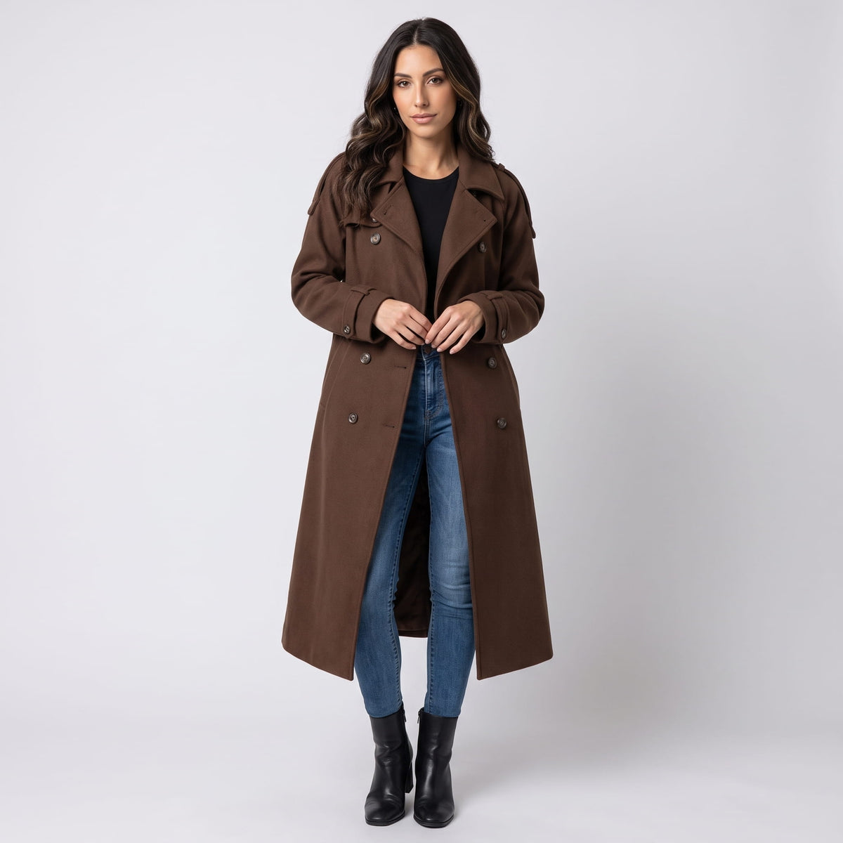 A woman wearing a brown wool trench coat with a double-breasted front and waist belt