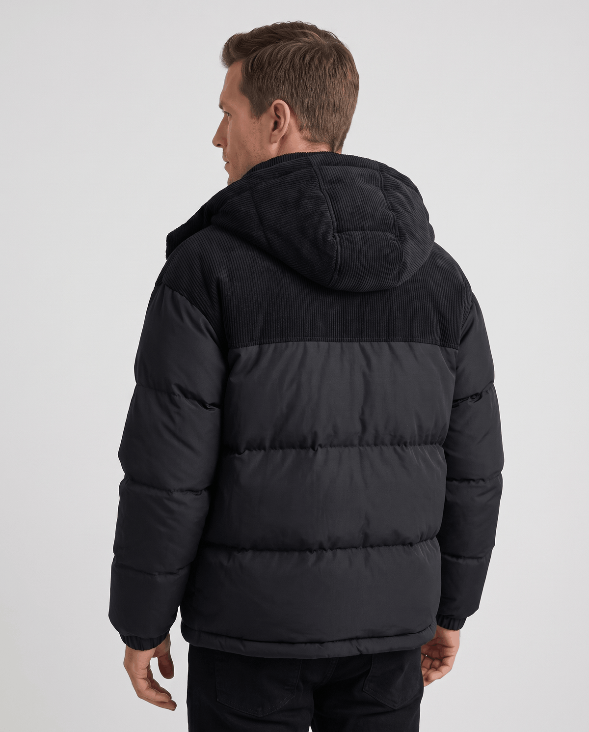 Black Dravon quilted puffer jacket back view showing corduroy hood and two-tone design