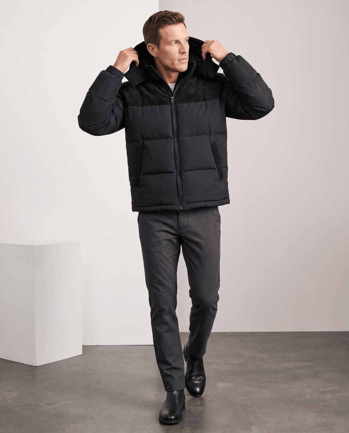 Man wearing black Dravon quilted puffer jacket with trousers, full-length front view
