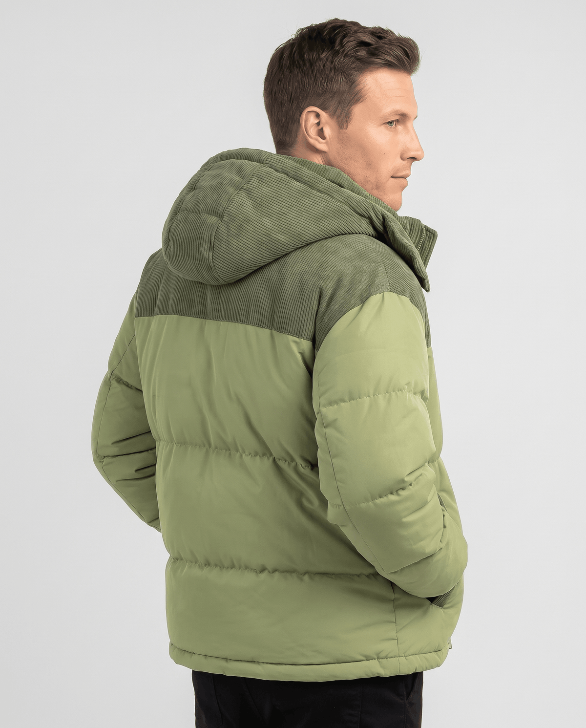 Green Dravon quilted puffer jacket back view showing corduroy hood and two-tone design