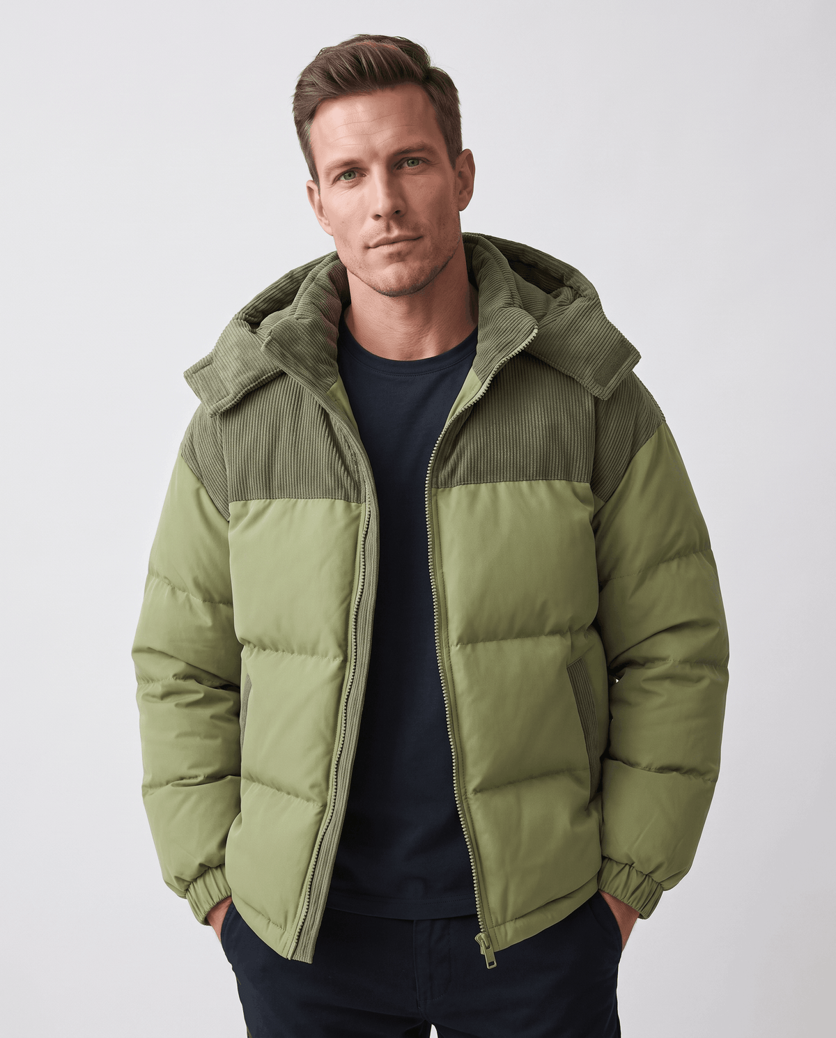 Man wearing green Dravon quilted puffer jacket, front view with corduroy hood and two-tone panels