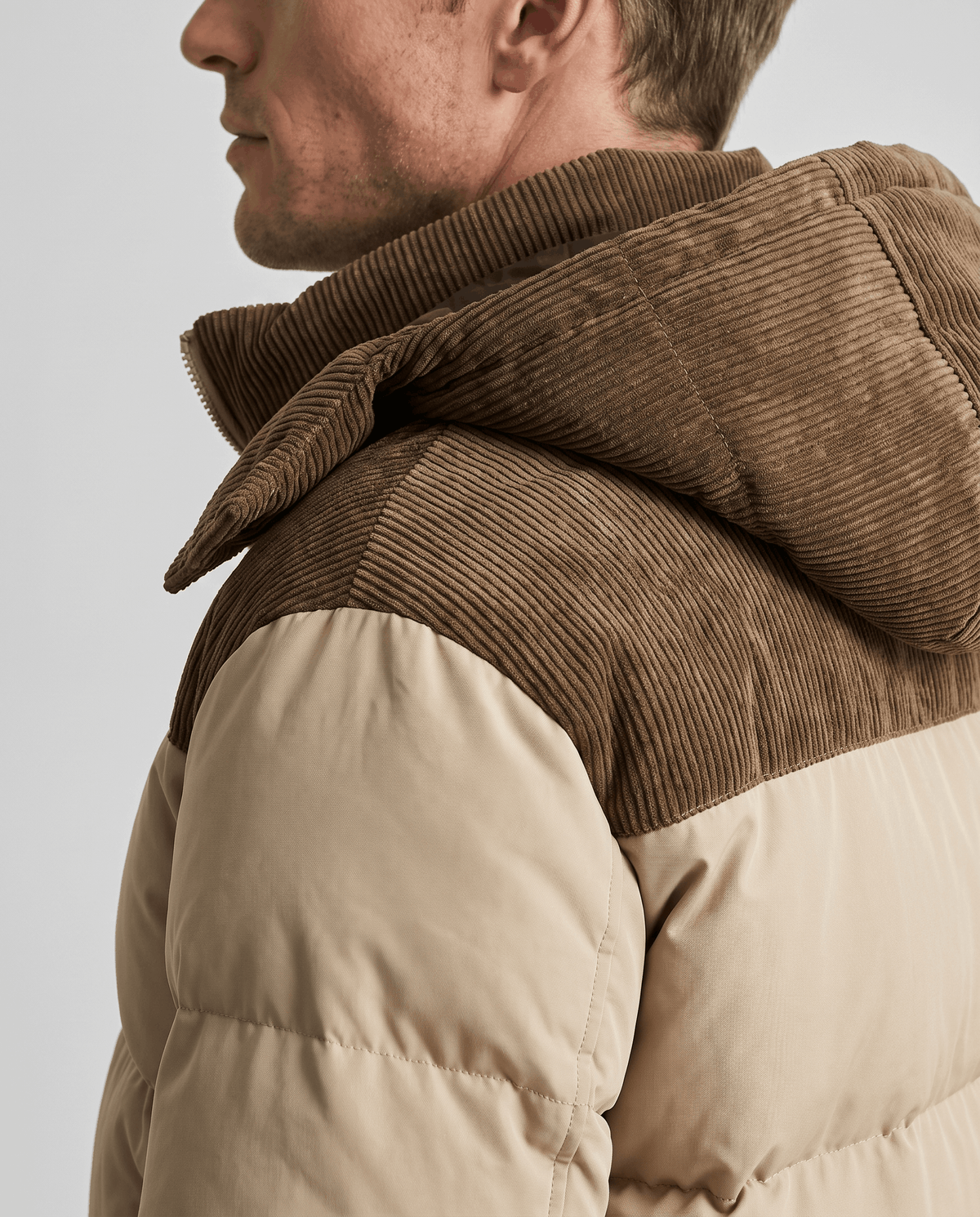 Close-up of khaki Dravon puffer jacket corduroy hood, collar and zip