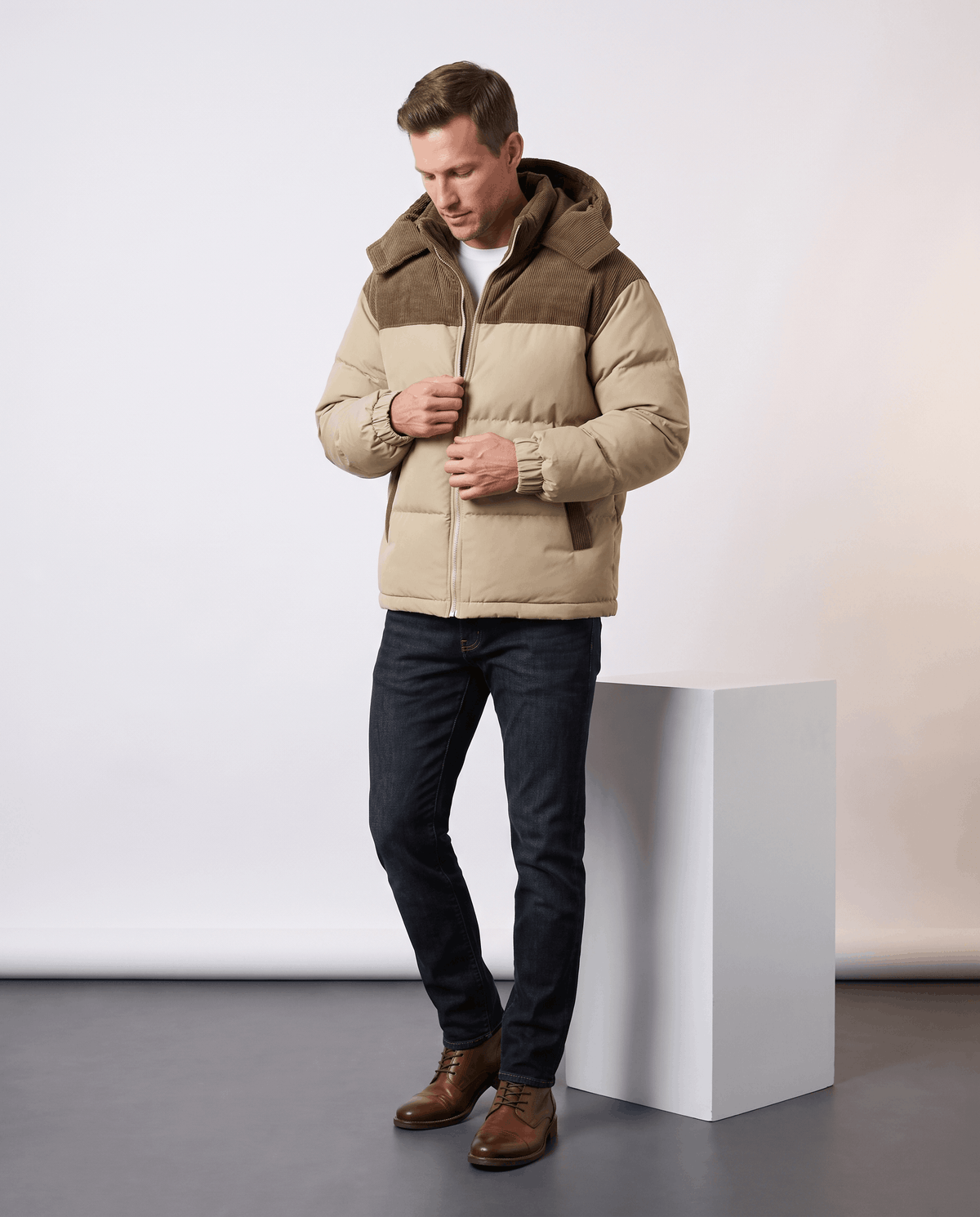 Man wearing khaki Dravon quilted puffer jacket with jeans, full-length front view