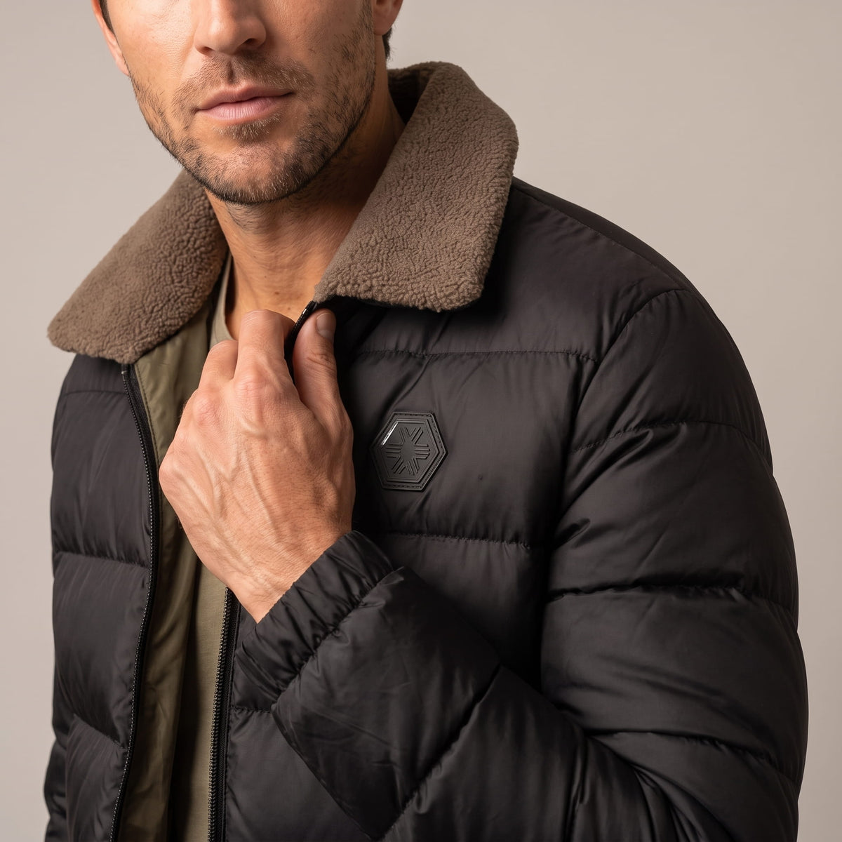 Close-up of black Julian puffer jacket fleece-lined collar and zip