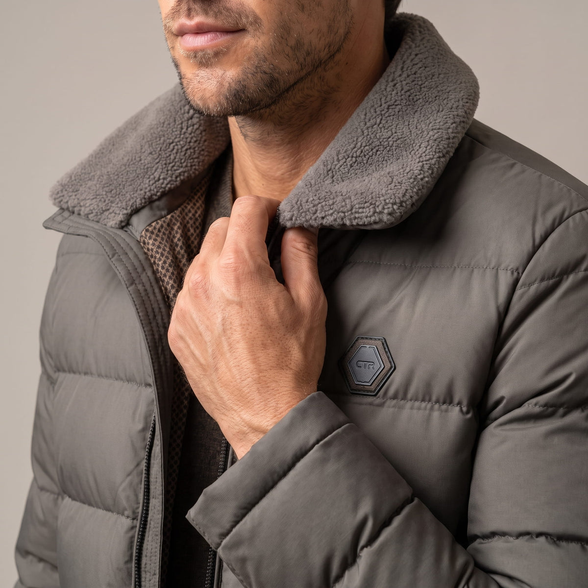 Close-up of gray Julian puffer jacket fleece-lined collar and zip