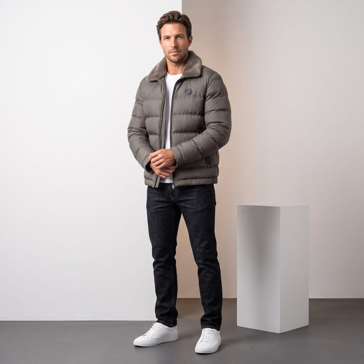 Man wearing gray Julian insulated puffer jacket with dark jeans, full-length front view