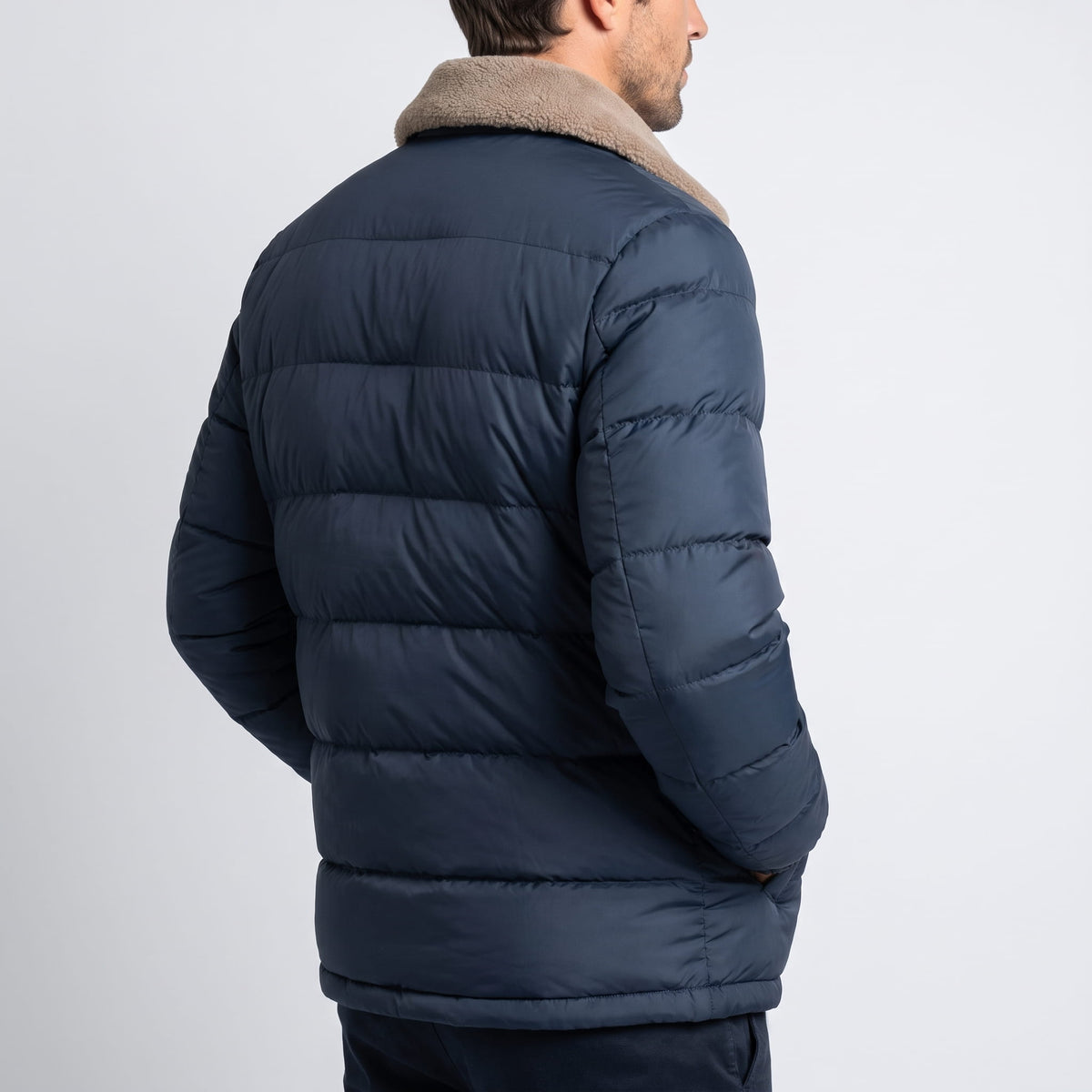 Navy blue Julian insulated puffer jacket back view showing quilted panels and fleece collar