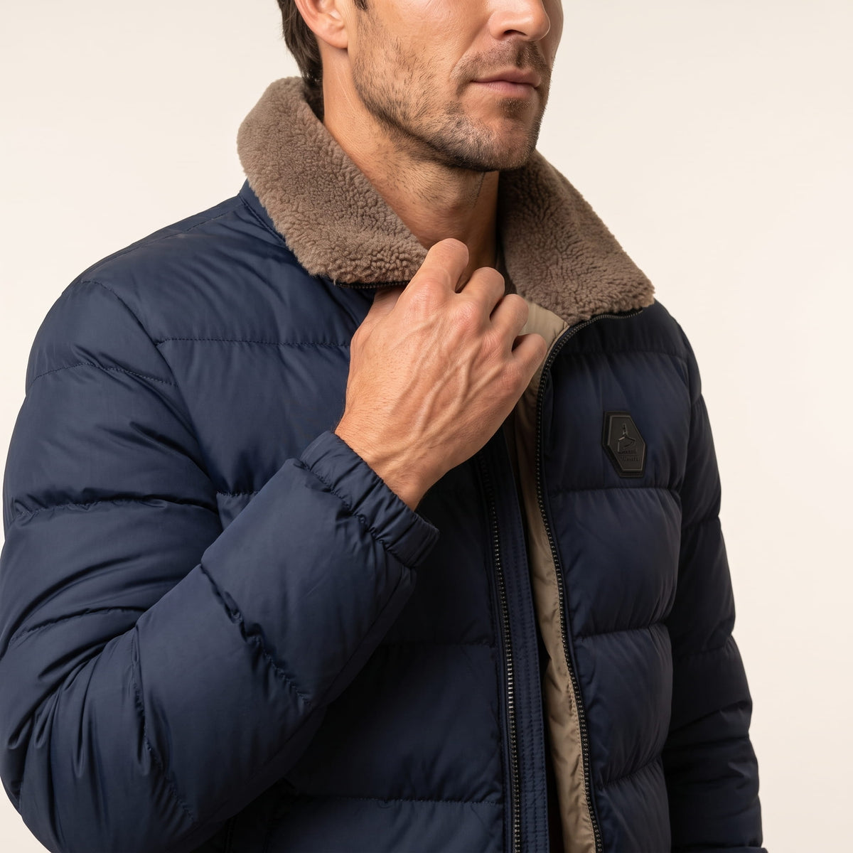Close-up of navy blue Julian puffer jacket fleece-lined collar and full-length zip
