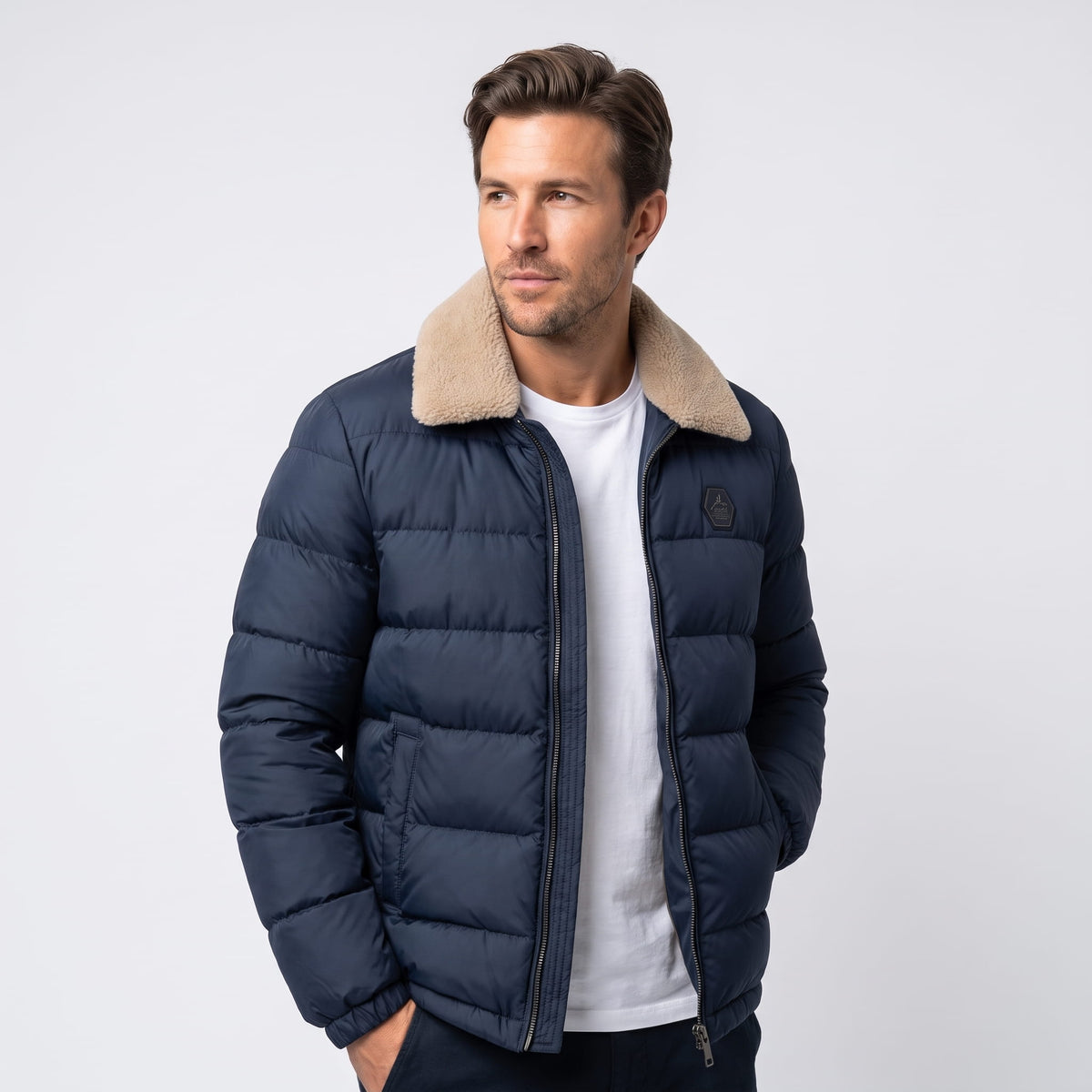 Man wearing navy blue Julian insulated puffer jacket, front view with fleece-lined collar