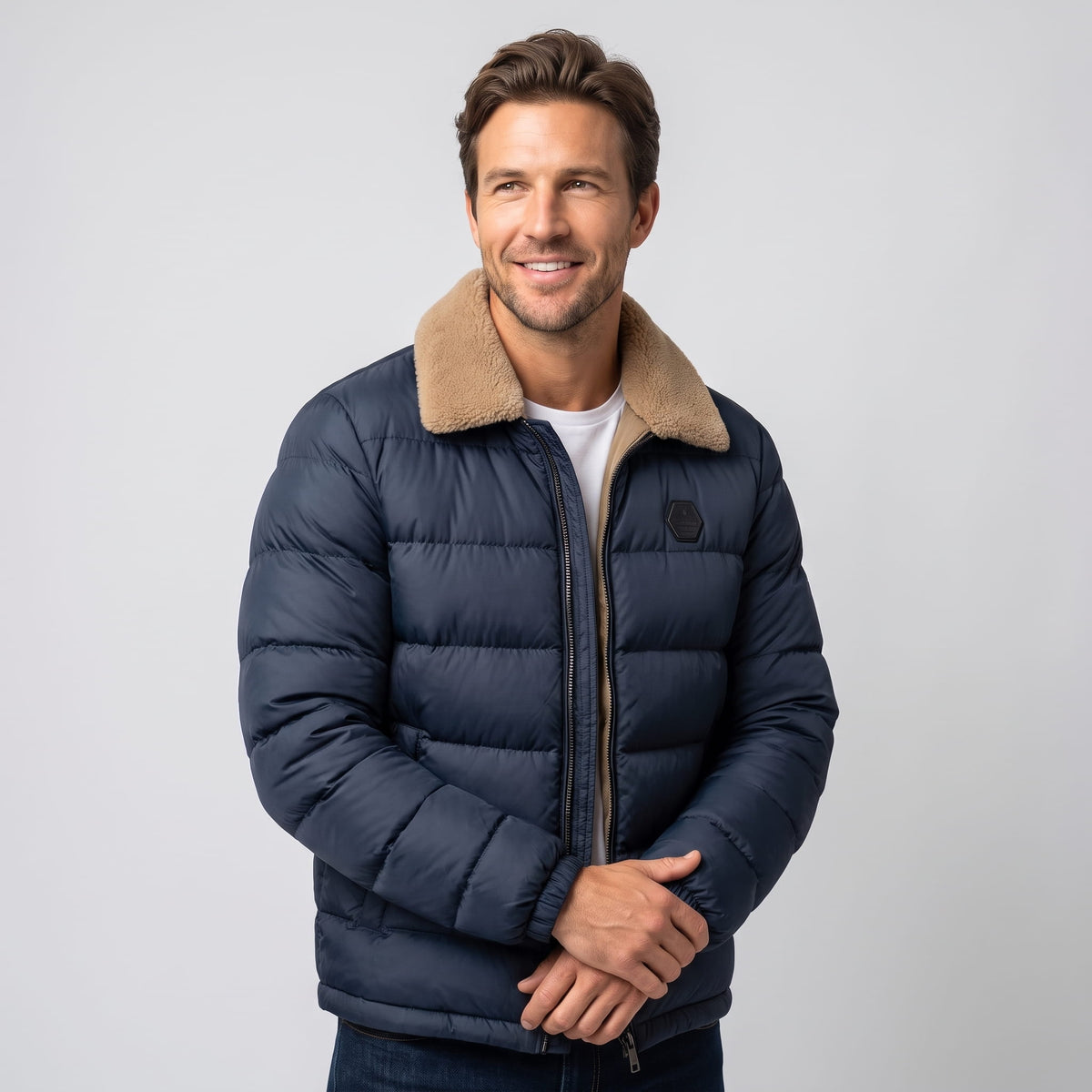 Man wearing navy blue Julian insulated puffer jacket, three-quarter front view