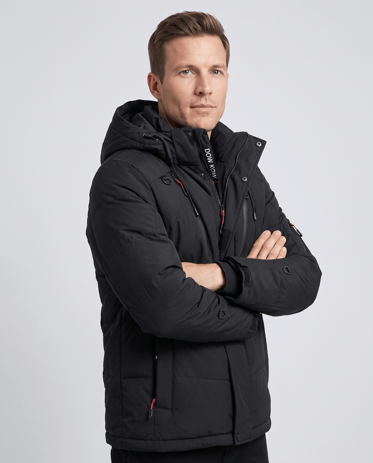 Man wearing black Paolo hooded puffer jacket, front view with arms crossed