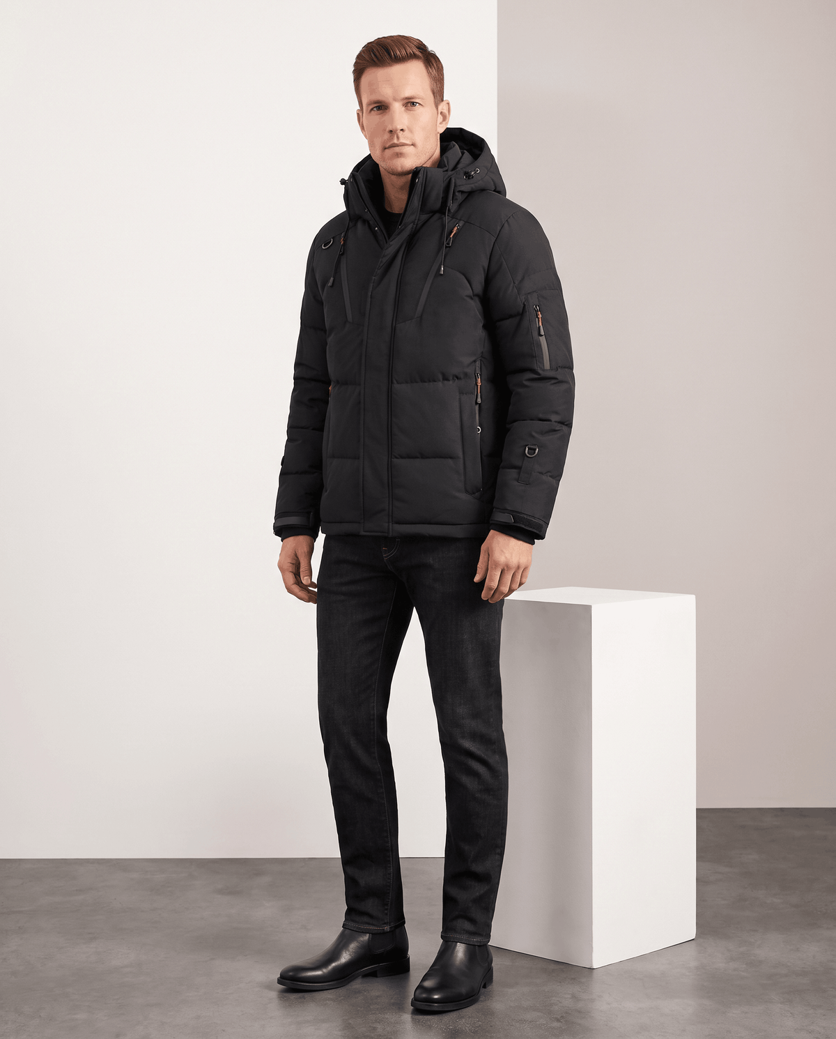 Man wearing black Paolo hooded puffer jacket with dark jeans, full-length front view