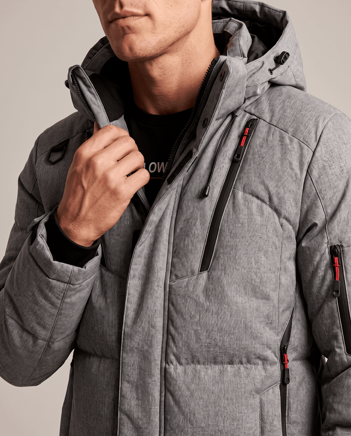 Close-up of gray Paolo puffer jacket collar, hood drawcord and zip pockets