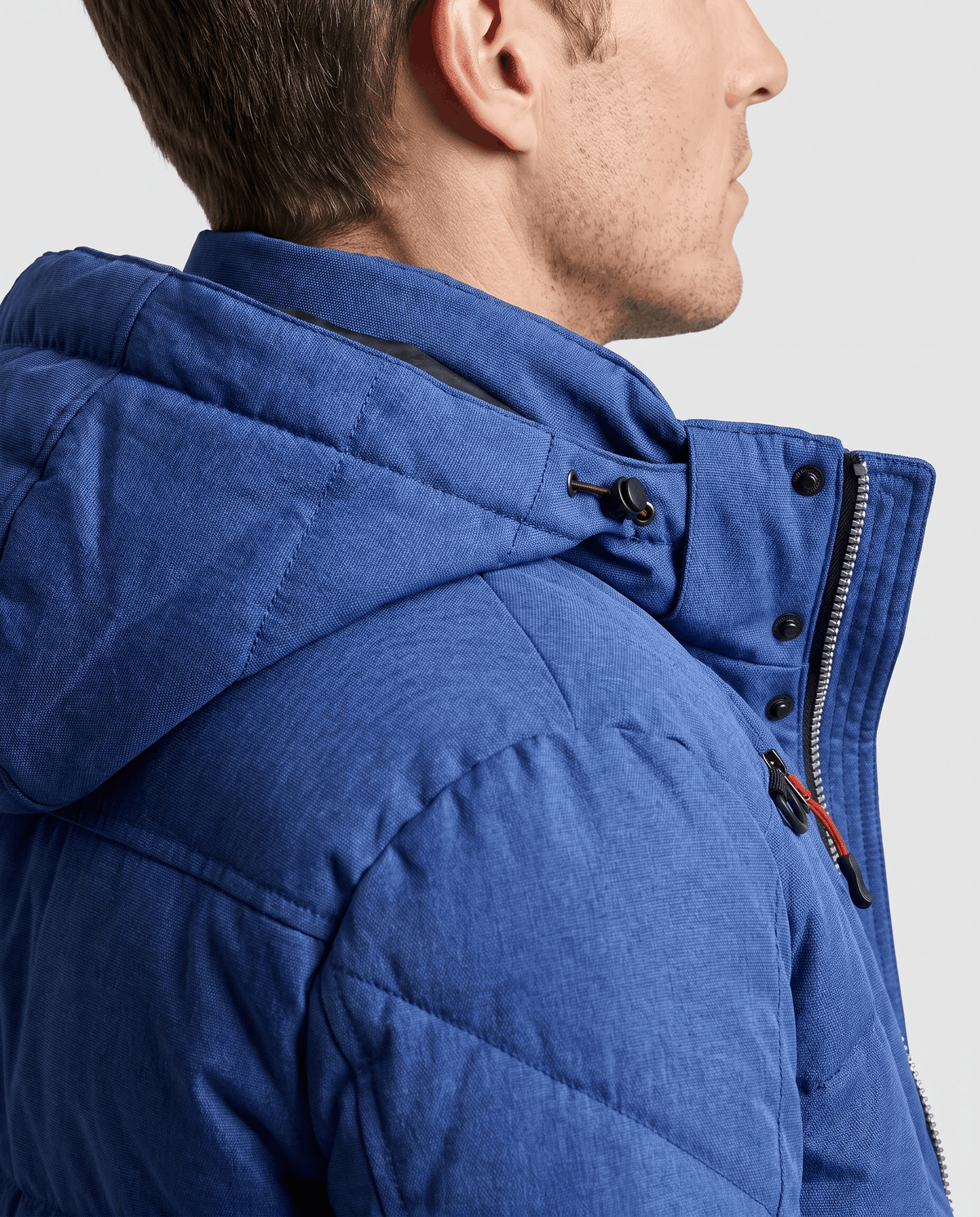 Close-up of navy blue Paolo puffer jacket hood, shoulder padding and zip