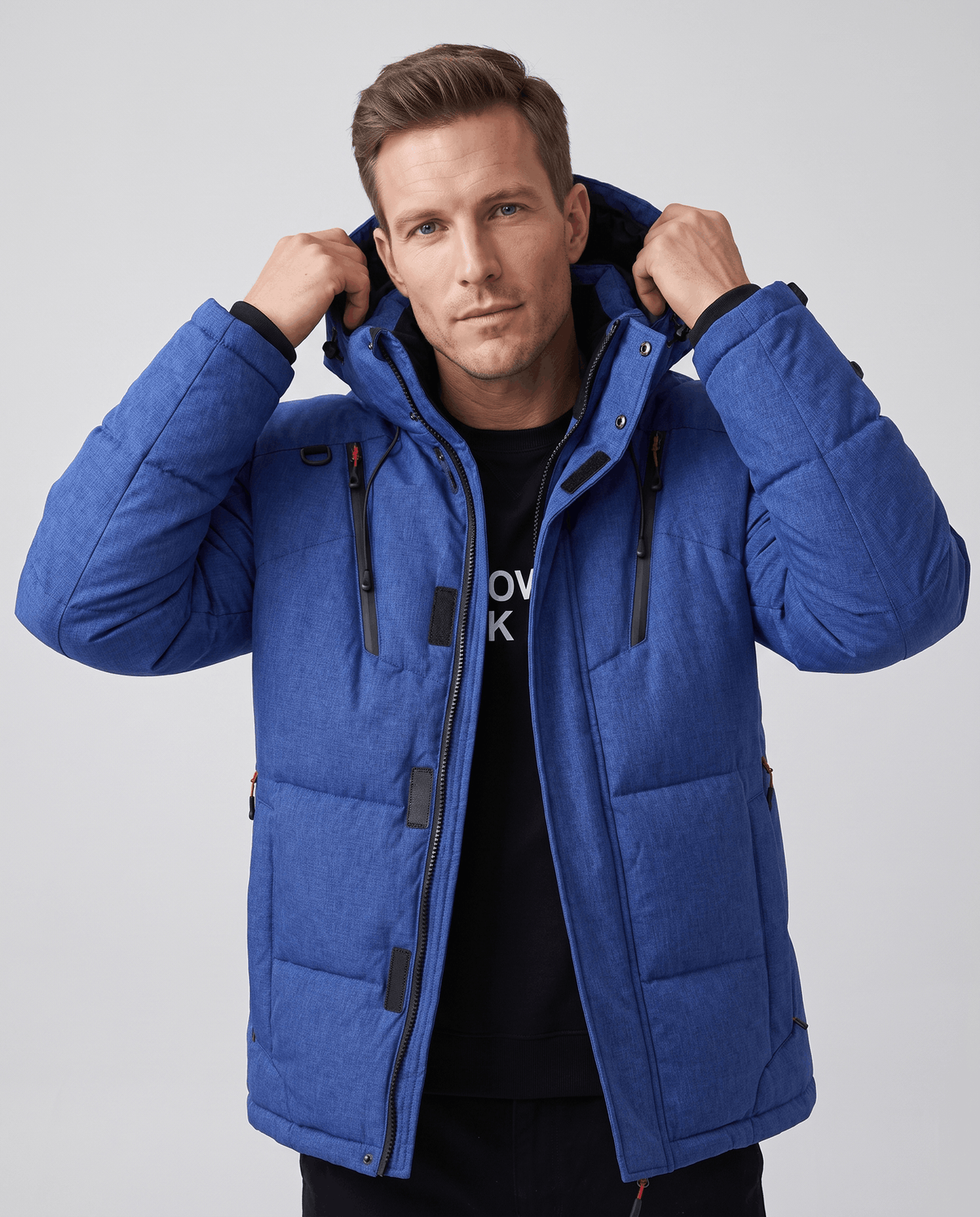 Man wearing navy blue Paolo hooded puffer jacket, front view worn open over a tee