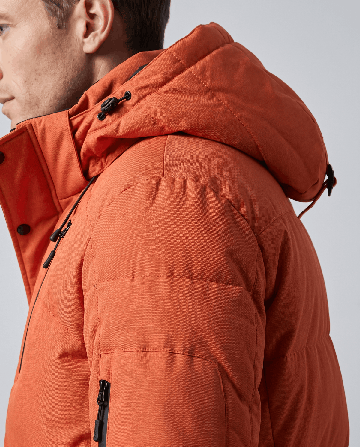 Close-up of orange Paolo puffer jacket hood and padded shoulder detail