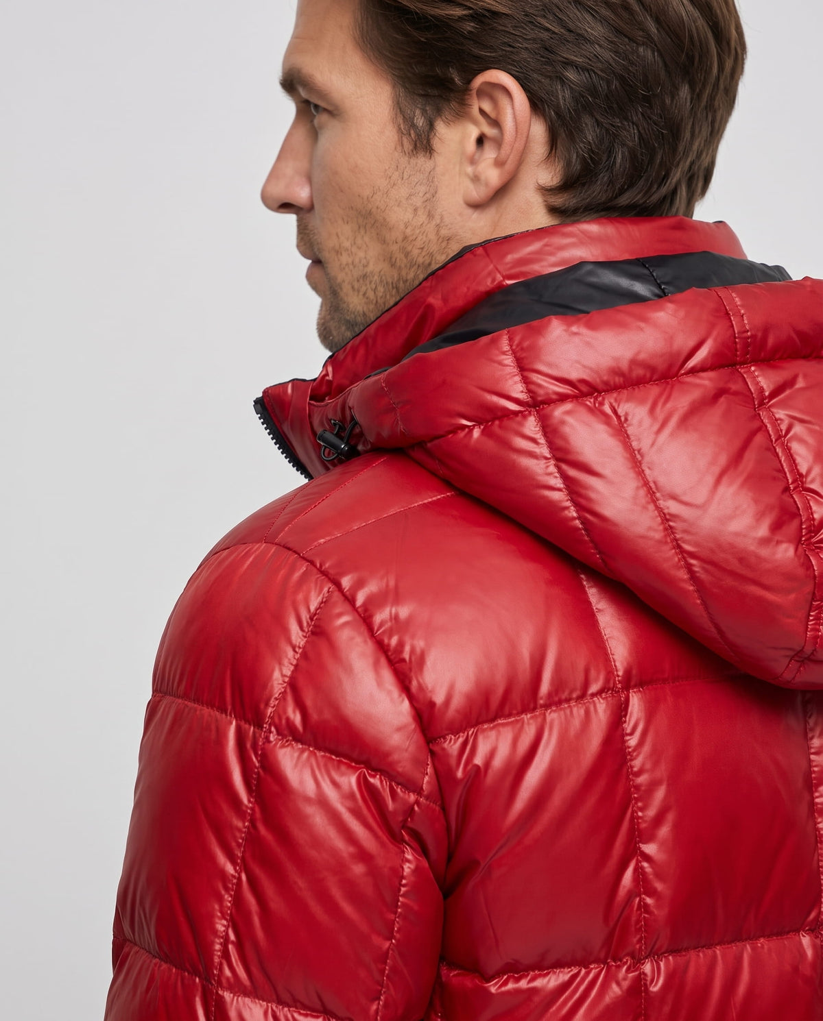 Close-up of red Robin puffer jacket hood and padded shoulder from behind