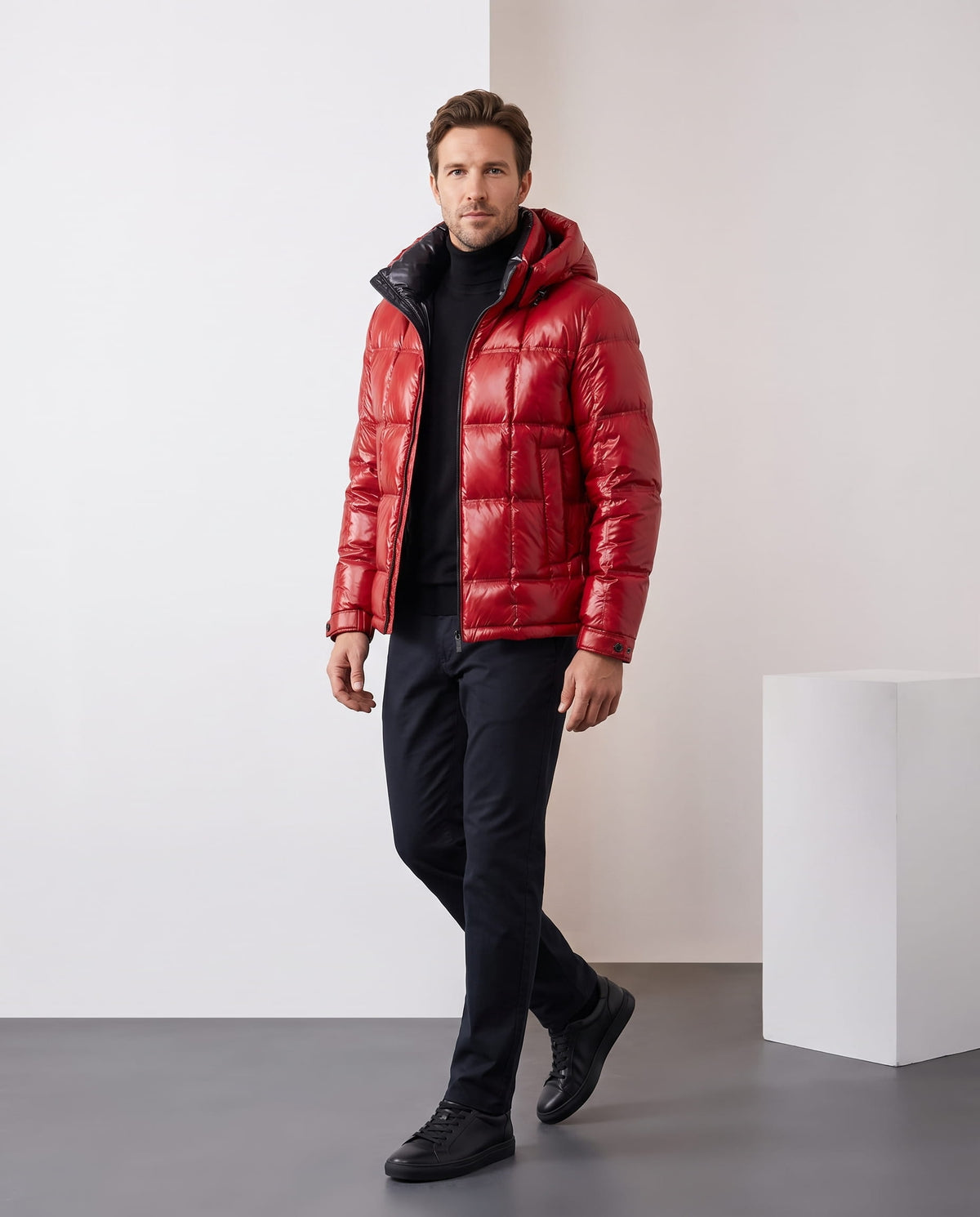 Man wearing red Robin hooded puffer jacket with dark trousers, full-length front view