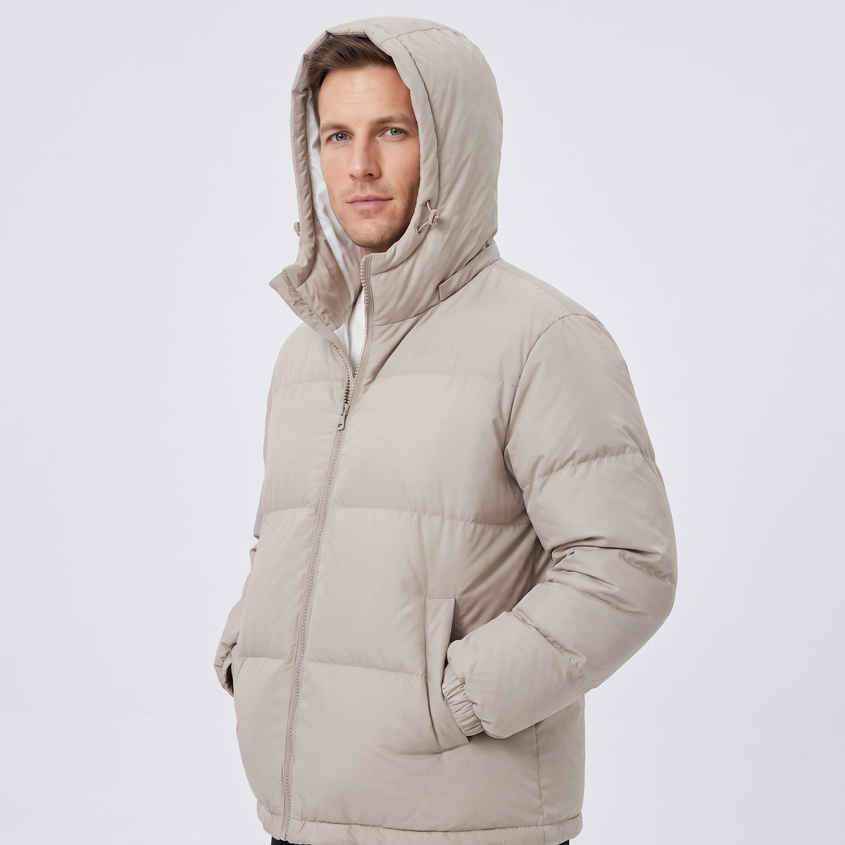 Man wearing beige Salvador insulated puffer jacket with the hood up