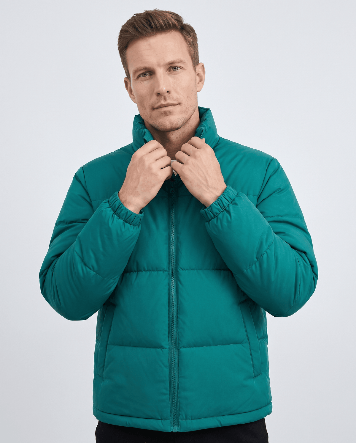 Man wearing deep teal Salvador quilted puffer jacket, front view with hand at the high collar