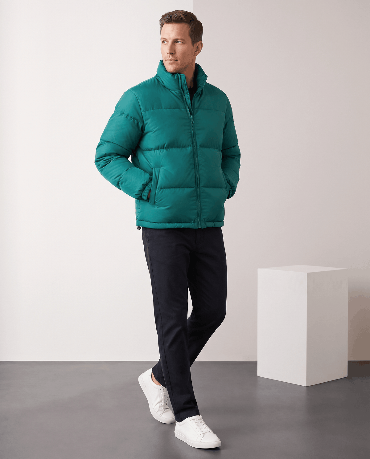 Man wearing deep teal Salvador quilted puffer jacket with dark trousers, full-length front view
