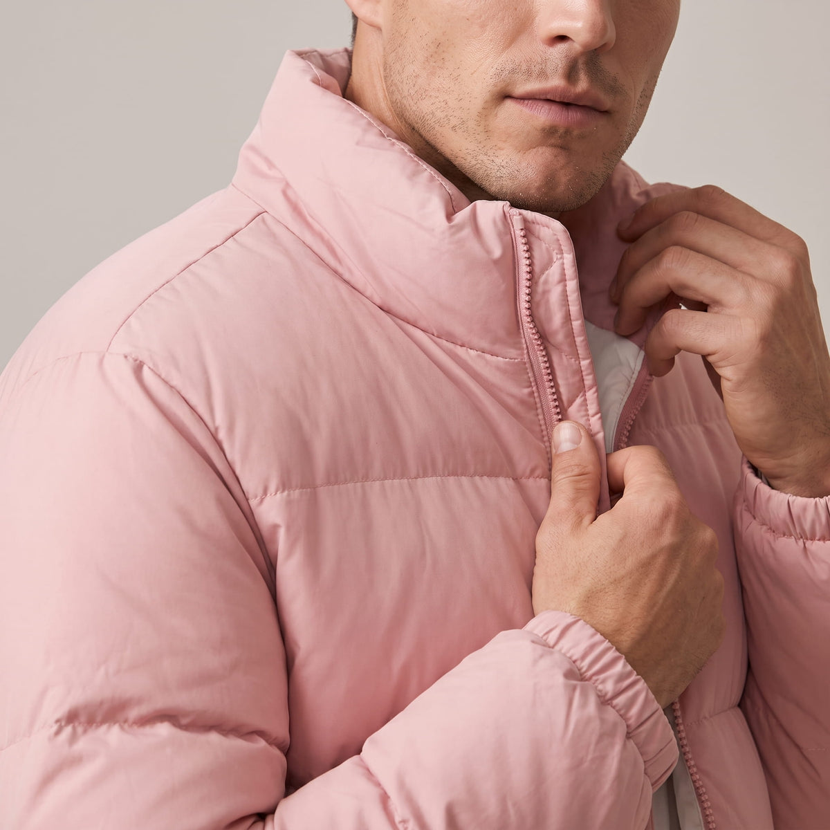 Close-up of dusty pink Salvador puffer jacket quilted shoulder and chest panels