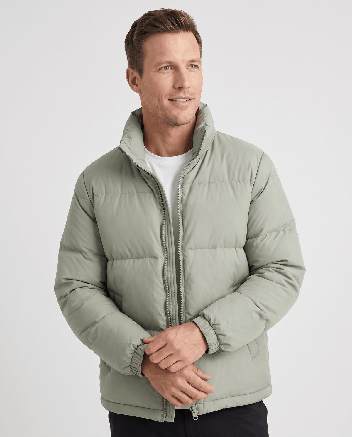 Man wearing sage Salvador quilted puffer jacket, front view with full-zip and high collar